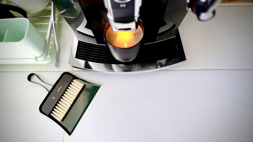 A coffee machine with a dustpan and brush