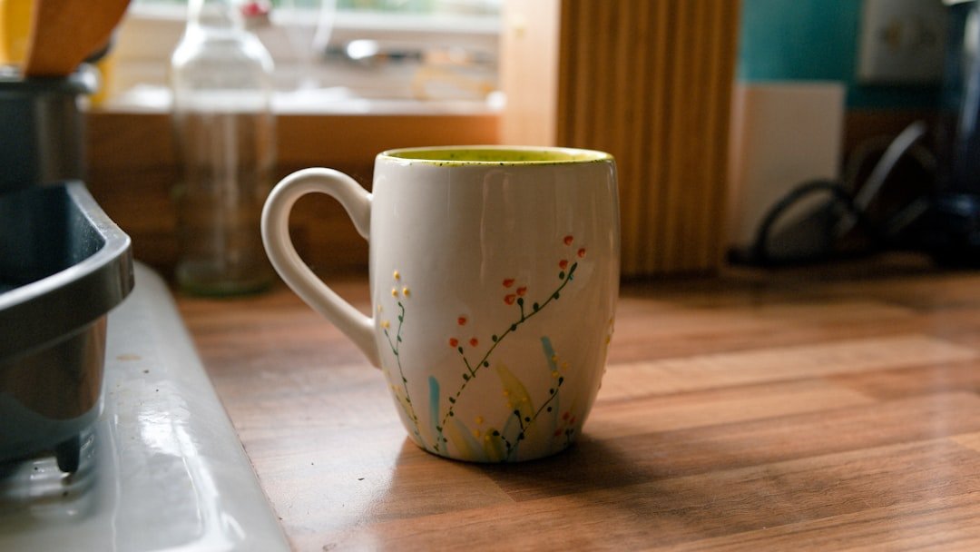 Decorated mug on a warm wooden counter for an evening drink.