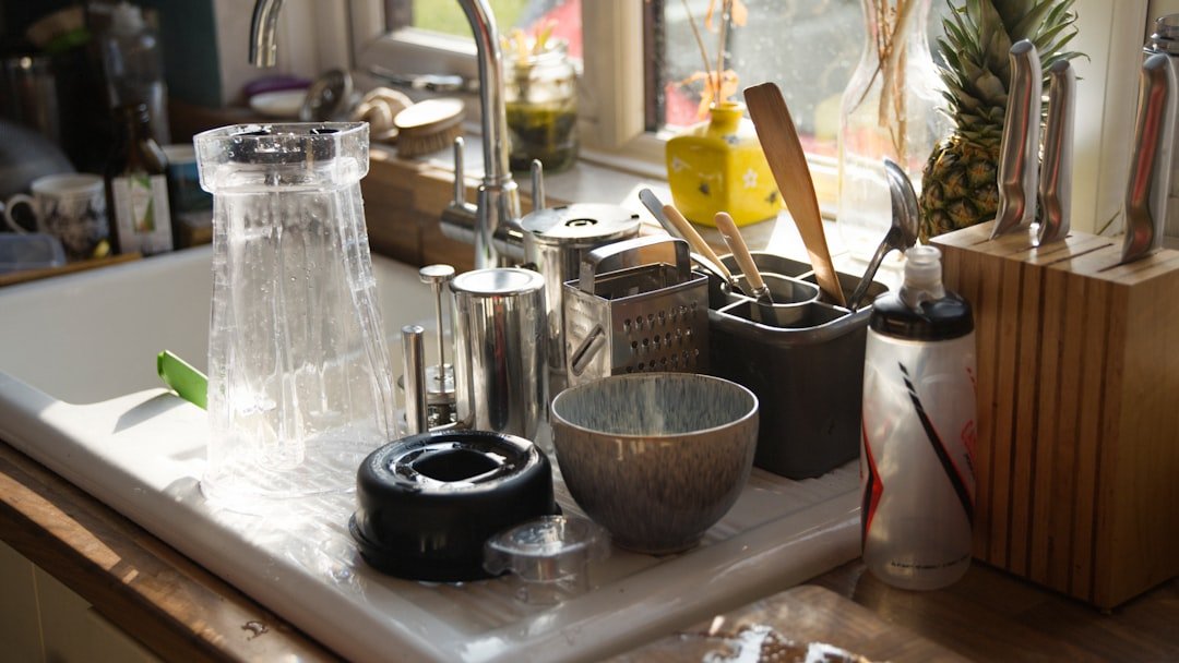 Kitchen sink area with cleaning tools and coffee gear ready to reset.