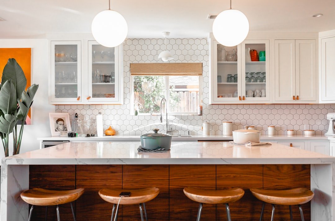 A kitchen counter near a kettle and cleanup supplies.
