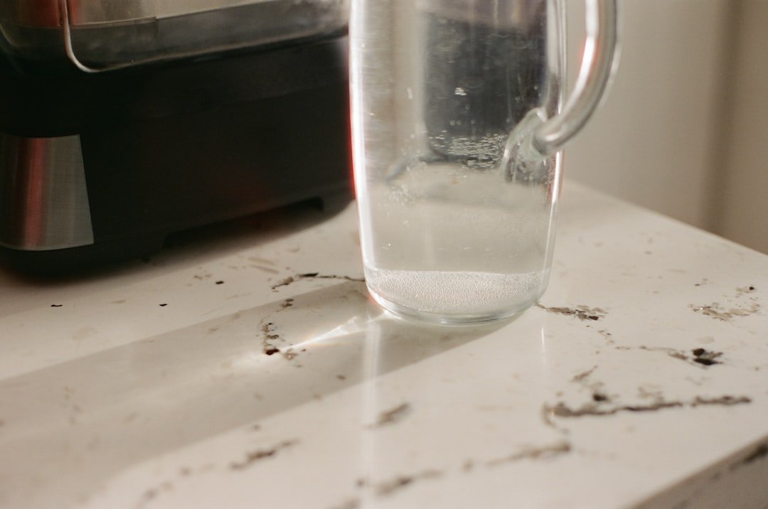 Clear pitcher on a kitchen counter for chilled drink prep.